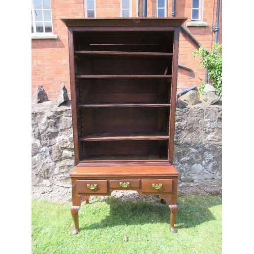 54 - (62) A low oak dresser with close boarded open shelves over fitted three drawers within a shaped fri... 