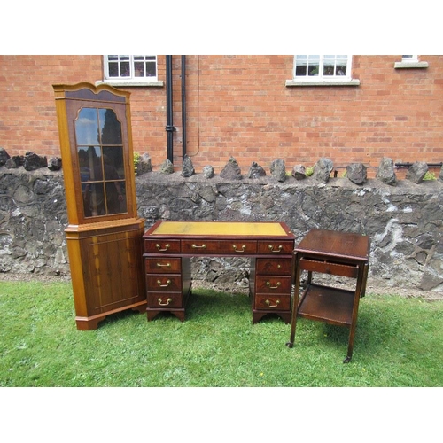 55 - (61) A reproduction mahogany desk, width 46.5ins, together with a yew wood free standing corner cupb... 