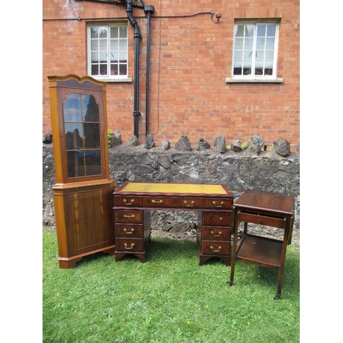 55 - (61) A reproduction mahogany desk, width 46.5ins, together with a yew wood free standing corner cupb... 