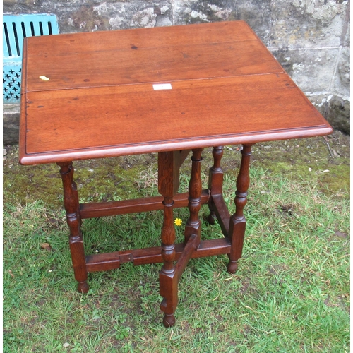 56 - An Antique oak table, fitted with a drop flap with gateleg action and a drawer