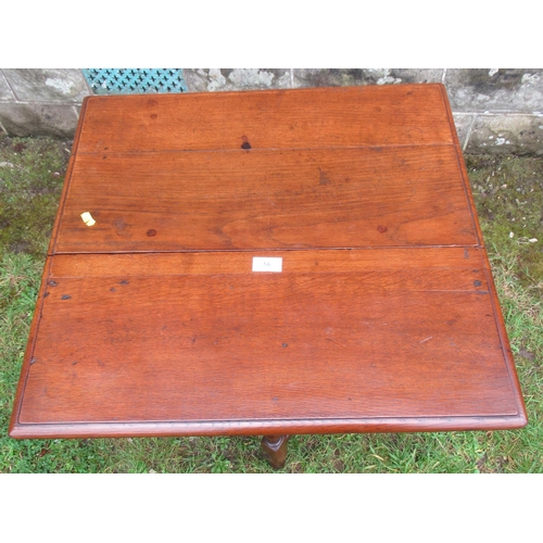 56 - An Antique oak table, fitted with a drop flap with gateleg action and a drawer