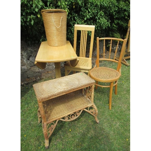 61 - A drop leaf kitchen table and two chairs together with a linen basket and a wicker shelf unit