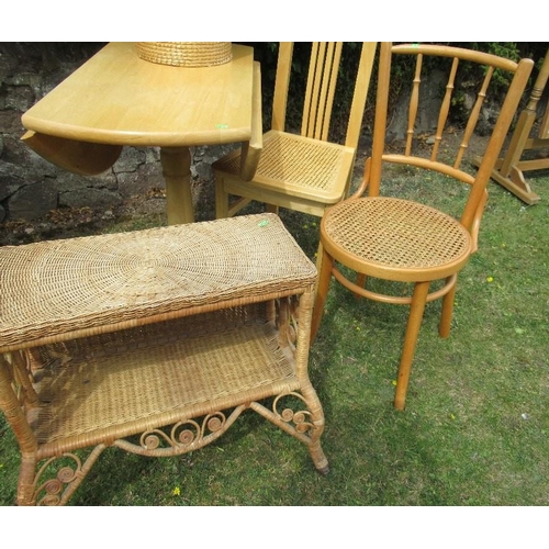 61 - A drop leaf kitchen table and two chairs together with a linen basket and a wicker shelf unit