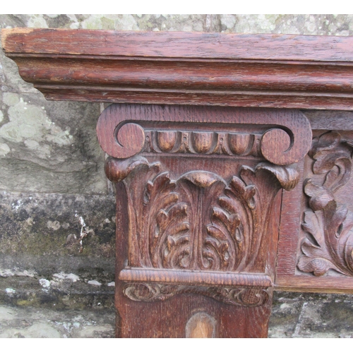 64B - An oak fire surround, with carved decoration