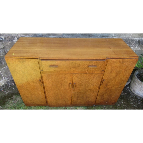 65 - A burr wood and mahogany breakfront sideboard, fitted with a drop front drawer over a double door cu... 