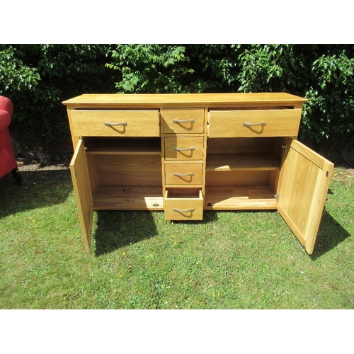 81B - (37) A Modern oak side board fitted a drawer and cupboard over four central drawers, width 61ins, de... 