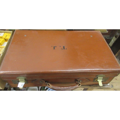 151 - A vintage brown leather suitcase, with initials