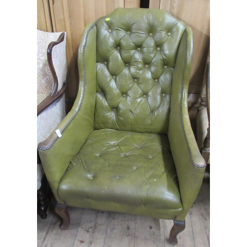 30 - A leather wing back deep button arm chair