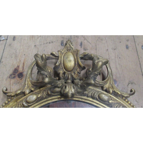 13 - An oval gilt frame wall mirror, overall height 28ins