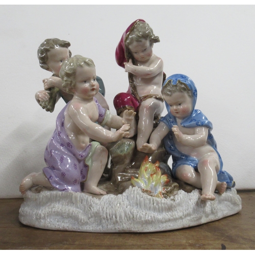 144 - A 19th century Meissen porcelain figure group, modelled as four putti seated round a fire, height 7i... 