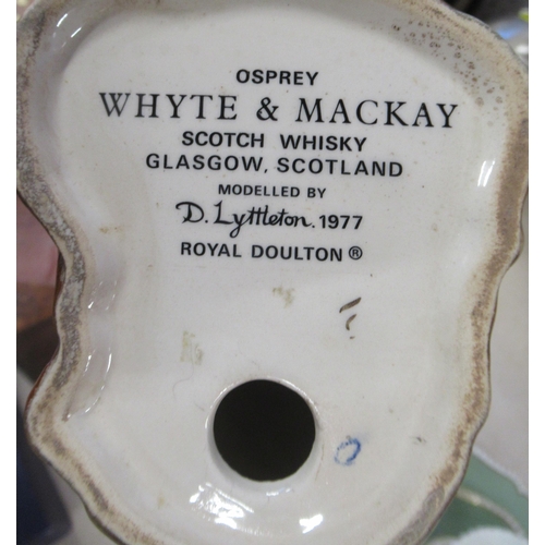 167 - A Royal Doulton model, Osprey, Whyte & Mackay Scotch Whisky Glasgow, together with a Staffordshire J... 