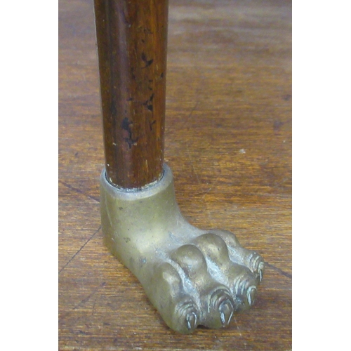 23 - A mahogany cake stand, with gilded brass ring handle and on gilded brass paw feet, height 33ins