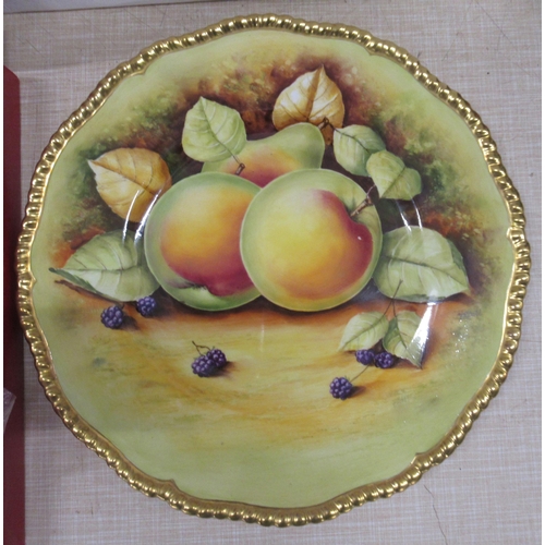 244 - A Spode golf cabinet plate and a Coalport cabinet plate, decorated with fruit