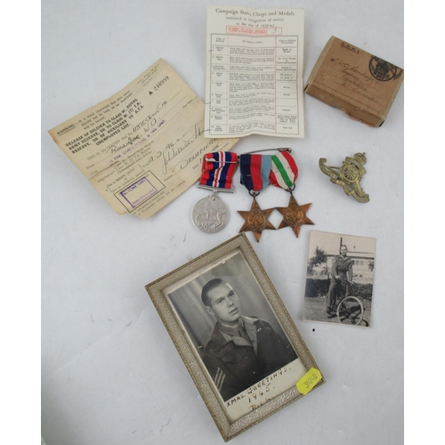 262 - A group of Second World War medals, to include The Italy Star and The 1939-1945 Star, a cap badge an... 