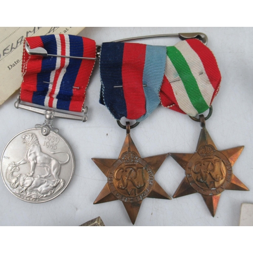 262 - A group of Second World War medals, to include The Italy Star and The 1939-1945 Star, a cap badge an... 