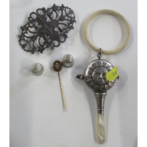 272 - A silver babies teether, together with a silver buckle, a stick pin and two thimbles