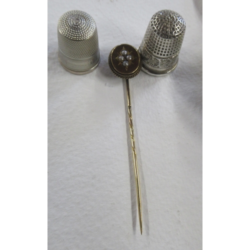 272 - A silver babies teether, together with a silver buckle, a stick pin and two thimbles