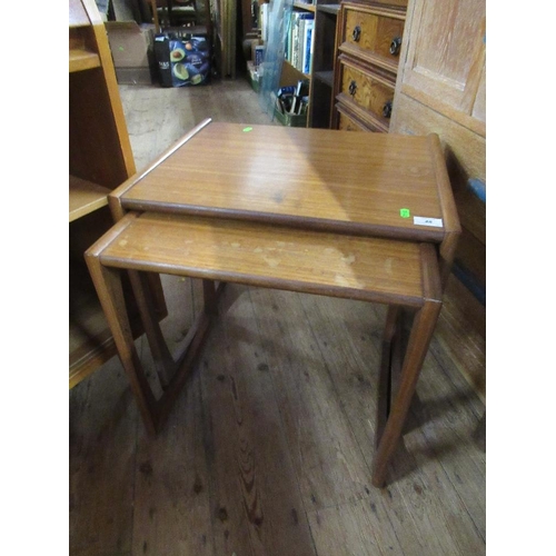 48 - A mid century bureau together with a nest of two tables