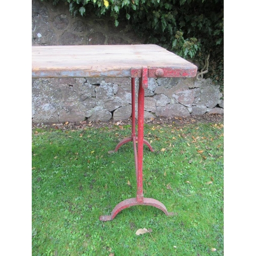 64 - A trestle table raised on wrought iron metal stands