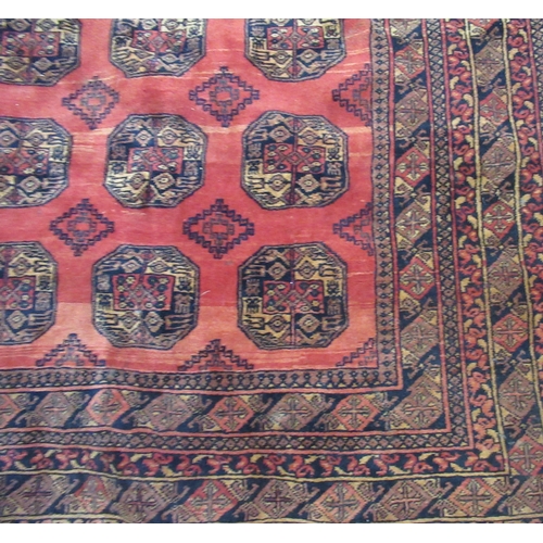 69A - An Eastern design red ground rug, 117ins x 78ins