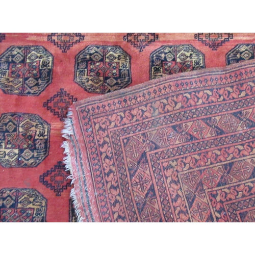 69A - An Eastern design red ground rug, 117ins x 78ins