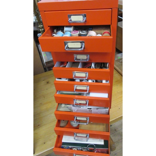 8 - A red metal filing set of drawers, together with sewing equipment