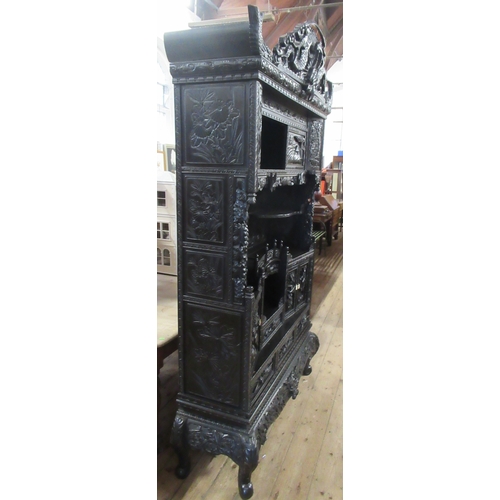 45 - An ebonised Chinese cabinet, fitted with cupboards and drawers, with carved decoration, height 86ins... 