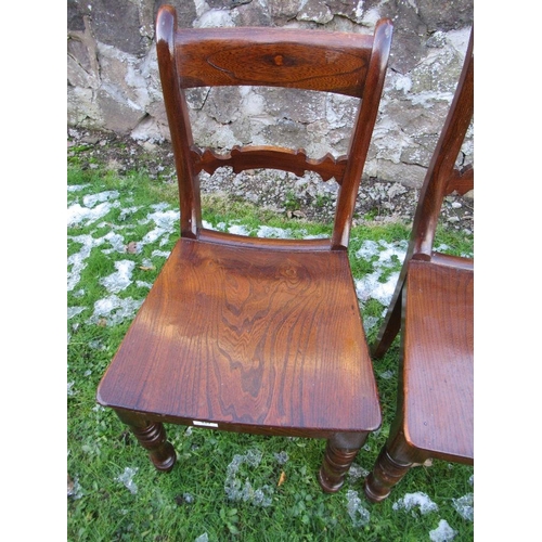 101 - A pair of 19th century stained oak saddle seat hall chairs raised on turned front legs