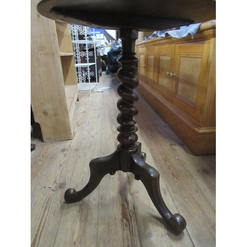 116 - A circular 19th century occasional table raised on a tripod base with turned column legs 20ins x 27i... 