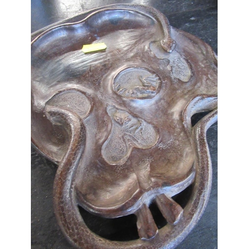 208 - A hardwood tray with an intertwined snake chasing a frog on a lily pad