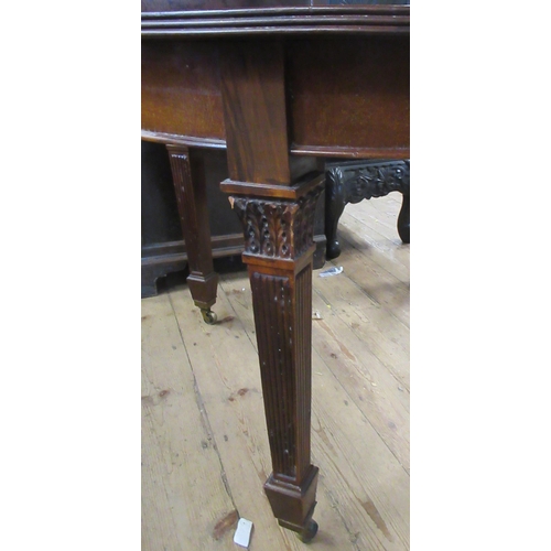 21 - An extending mahogany dining table with two leaves, diameter 48.5ins w