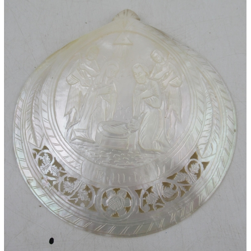 223 - A carved mother of pearl shell, carved with a scene of figures round a crib and titled Bethlehem