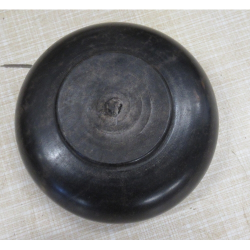 226 - An Antique treen turned ebony salt, with inset centre