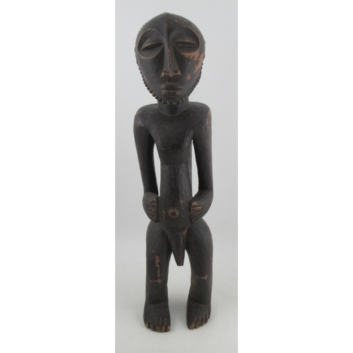 234 - An African tribal fertility figure, of a naked standing male, height 29ins