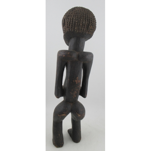 234 - An African tribal fertility figure, of a naked standing male, height 29ins