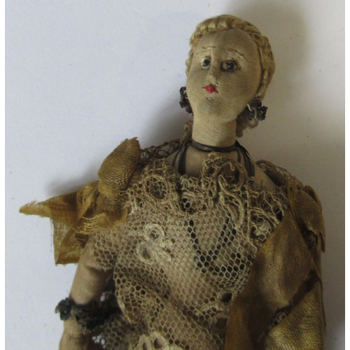 244 - A 19th century continental doll, possibly Maltese , with bead eyes and lace dress