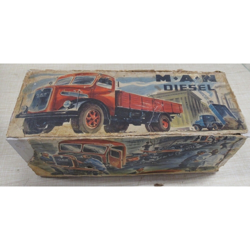 248 - A German Arnold Toys M.A.N. diesel clockwork tinplate and plastic tipper truck, 1950s, with key, ori... 