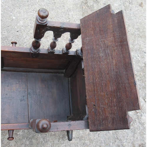 26 - An antique oak child's crib, with carved panels and a raising canopy, length 38ins