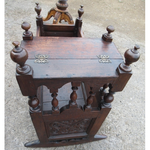 26 - An antique oak child's crib, with carved panels and a raising canopy, length 38ins