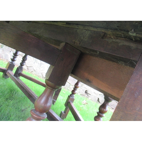 51 - An 18th century oak oval wake table, with double gate leg action, with turned legs and supports