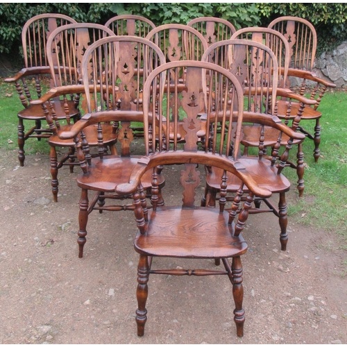 52 - A Harlequin set of 10 matched antique Windsor chairs, the high spindle back with a central christmas... 