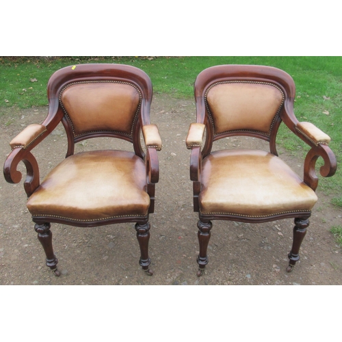 54 - A pair of 19th century mahogany showwood armchairs, with leather upholstery