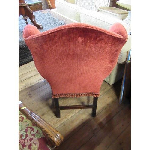 58 - An 18th century style wing arm chair with molded arms