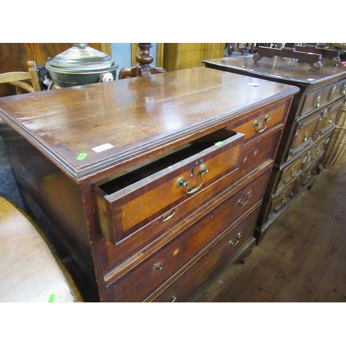 63 - A late Georgian oak chest fitted two short drawers over three graduated long drawers below a cross b... 