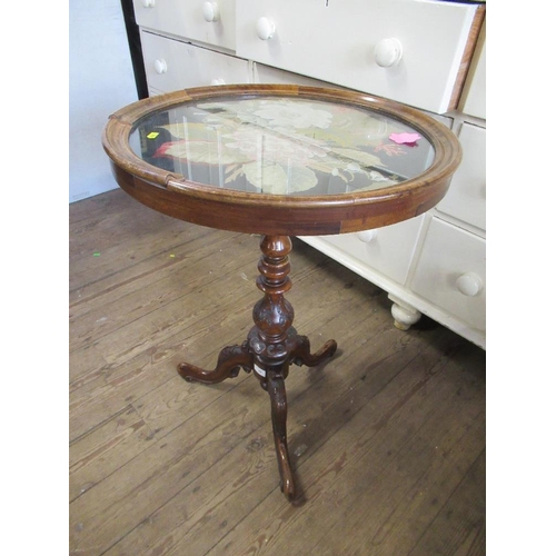 70 - A circular occasional table, the top inlaid with a tapestry panel and raised on part carved tripod l... 