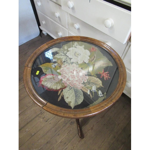 70 - A circular occasional table, the top inlaid with a tapestry panel and raised on part carved tripod l... 