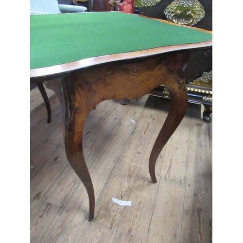 73 - A 19th century burr walnut serpentine shaped fold over  card table with quarter veneered cross bande... 