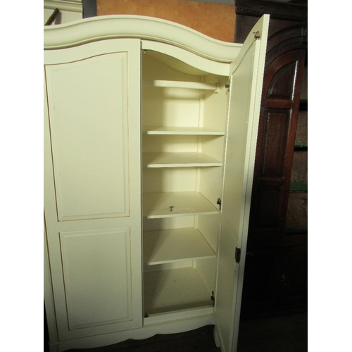 76 - A modern white wood and two door wardrobe with arched top and short splayed feet 40ins x 23.5ins x 7... 