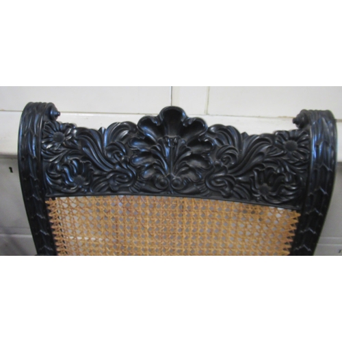 79 - A pair of 19th century possibly ebony or coromandel, Anglo Indian arm chairs with part carved frieze... 