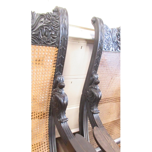 79 - A pair of 19th century possibly ebony or coromandel, Anglo Indian arm chairs with part carved frieze... 